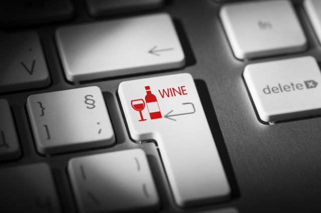 Close up of computer keyboard with a wine key instead of the enter key.